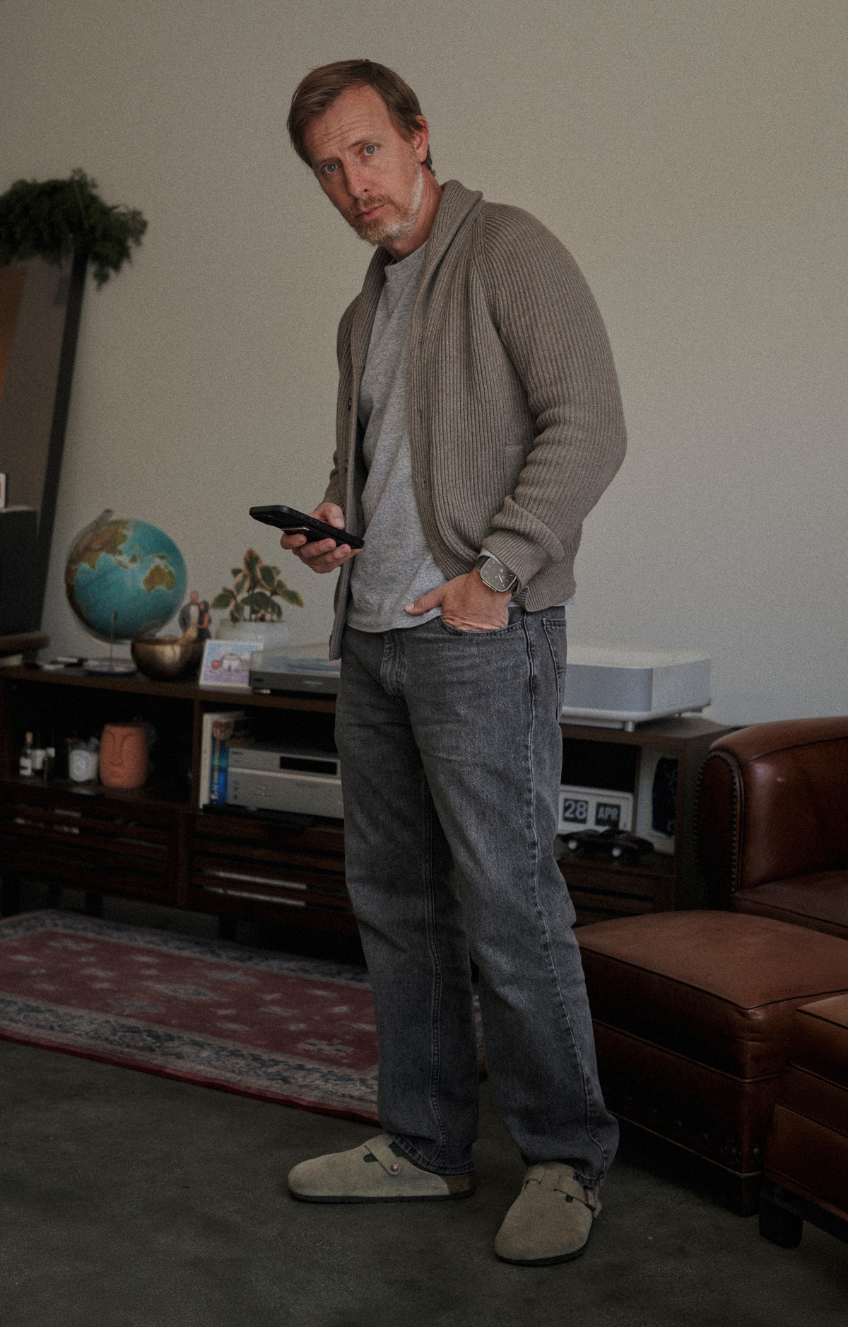 Man wearing Levi's 555 relaxed straight jeans in a faded black wash