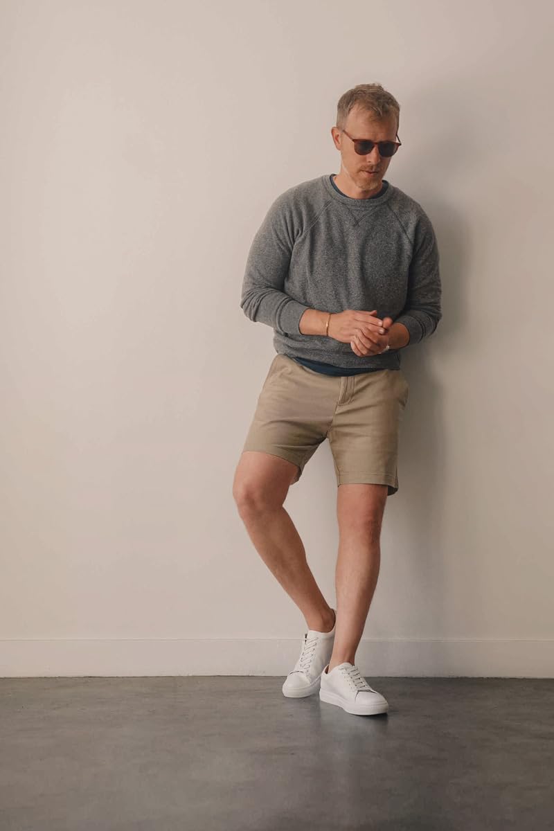 Man wearing Nautica 6-inch deck shorts in true khaki with a gray sweatshirt and white sneakers