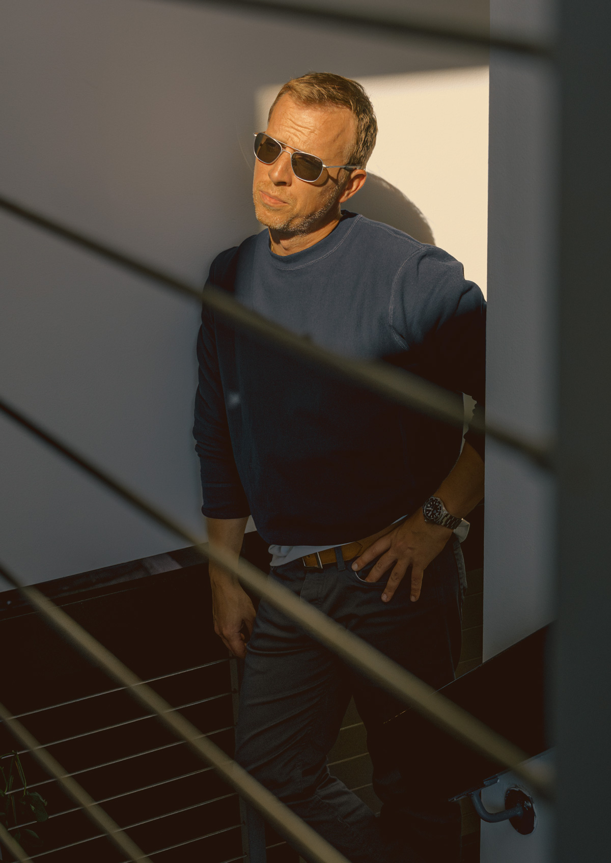 Man wearing Randolph Engineering matte chrome aviator sunglasses in golden-hour light