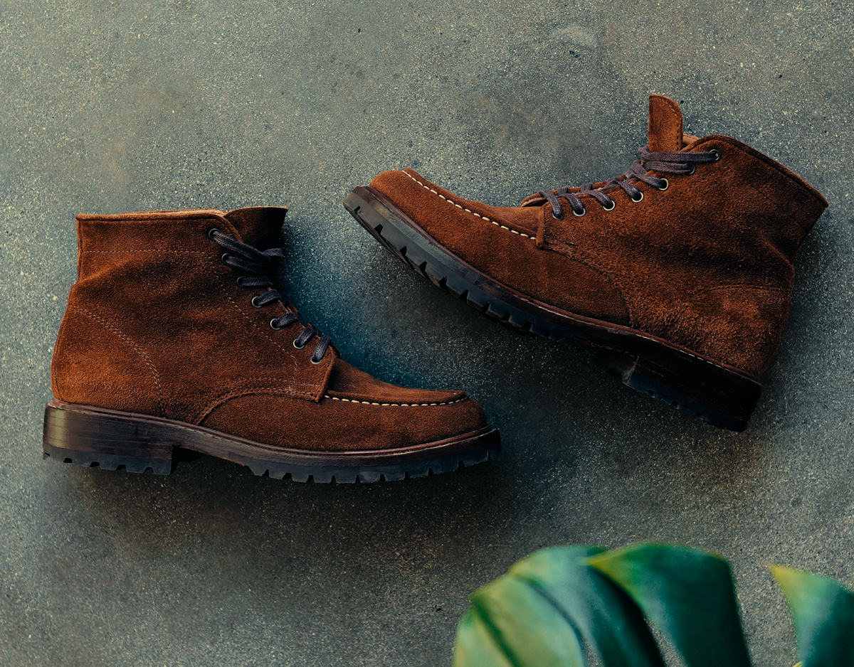 Pair of Thursday Diplomat moc toe boots in Cinnamon suede on a concrete floor