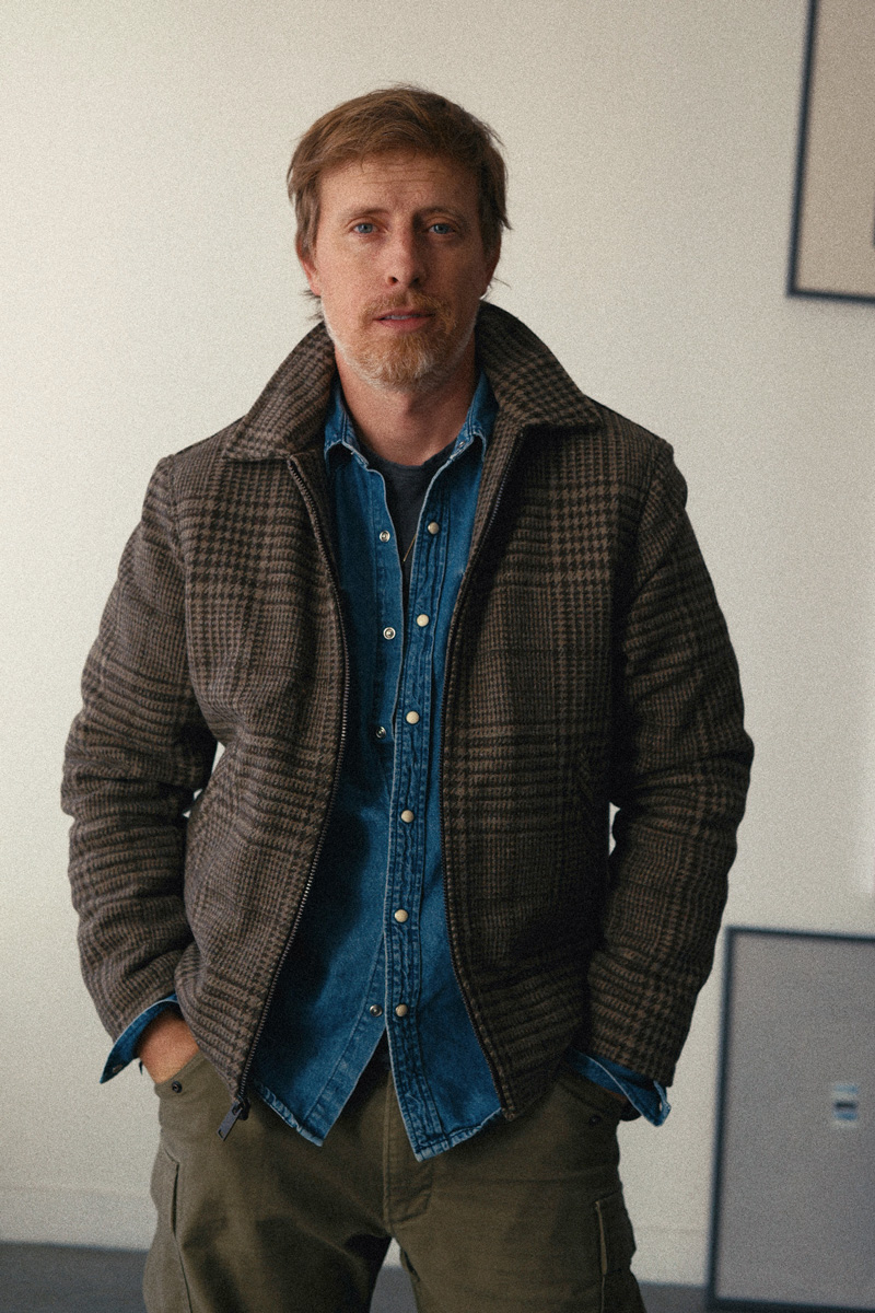 Thursday Station Jacket in Elmwood glen plaid worn open over a snap-front denim shirt
